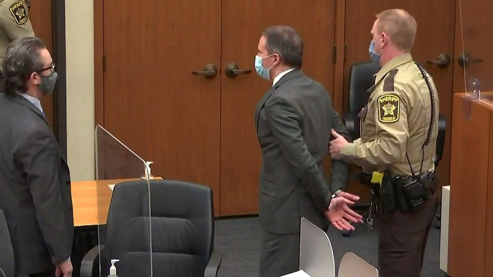 Former Minneapolis police officer Derek Chauvin is led away in handcuffs
