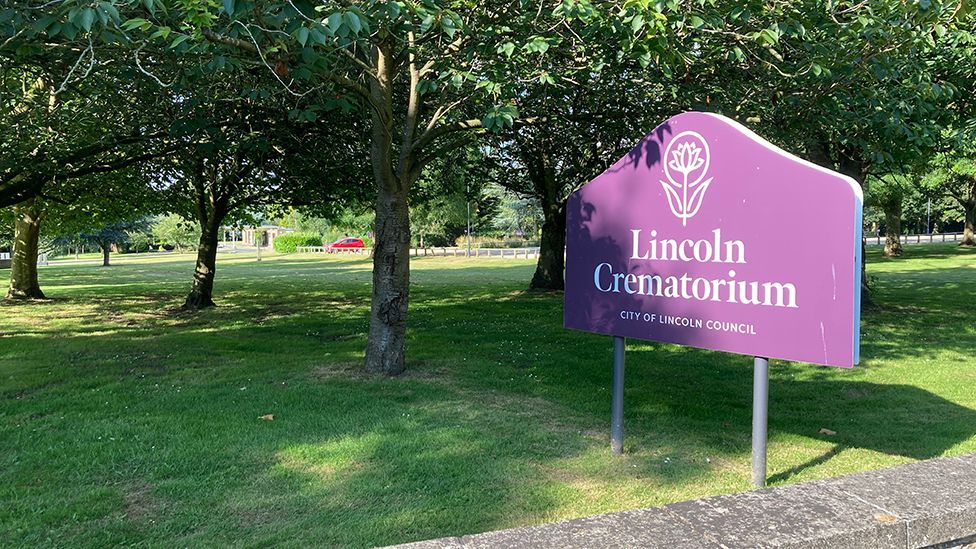 A purple sign saying Lincoln Crematorium by the entrance wall