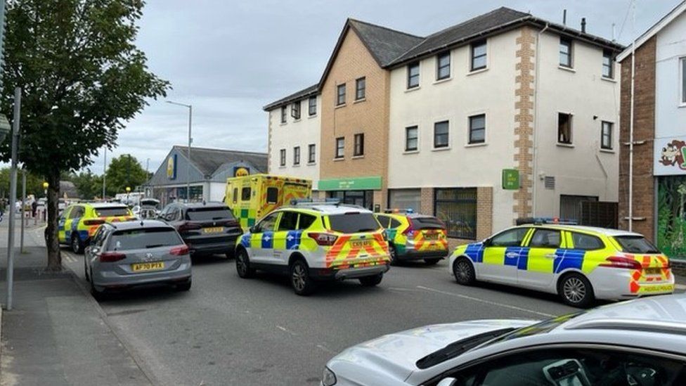 Police cars outside Pwllheli job centre