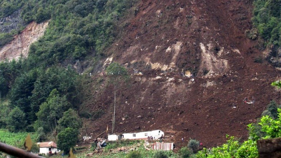 View a mudslide that killed 12 people in the village of San Pedro Soloma, Huehuetenango Department, Guatemala, on June 20, 2017.
