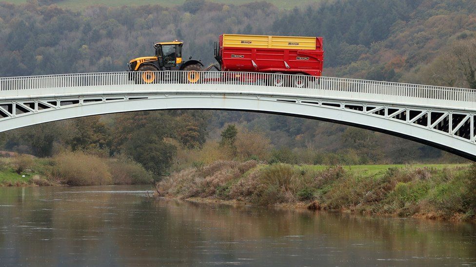 Farm traffic crosses Bigsweir Bridge, over the River Wye, dividing England (on the right) from Wales (on the left) near the town of Llandogo in south Wales on October 17, 2020
