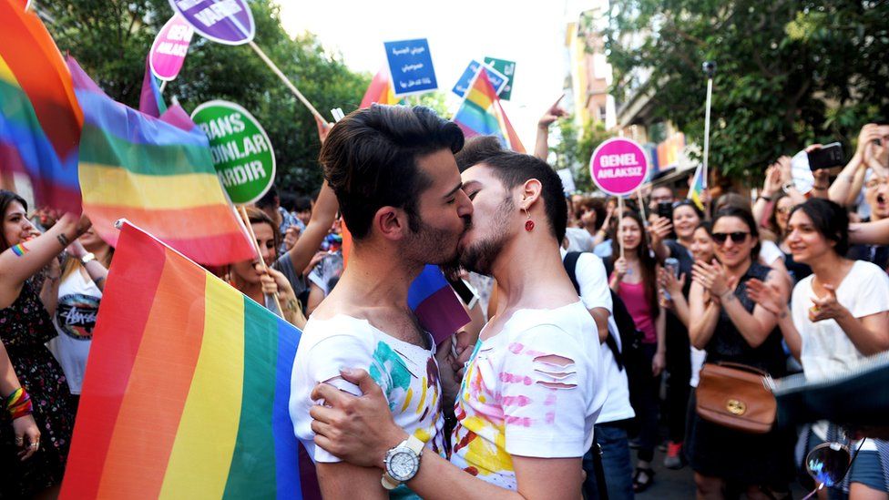 A gay couple kisses during the Gay Pride parade on 28 June 2015 in Istanbul.
