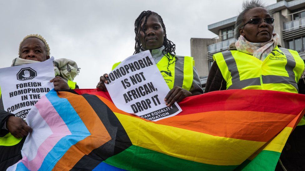 Campaigners from African Equality Foundation protesting with pro-gay banners opposite Westminster Abbey, London
