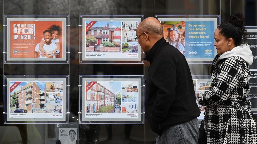 People looking in estate agent's window