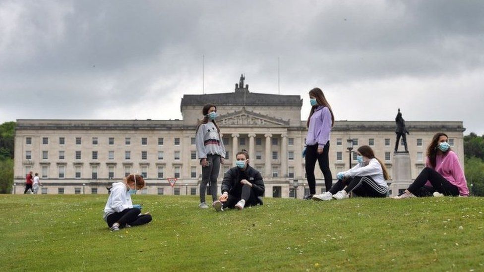 Teenagers wearing masks outside Stormont