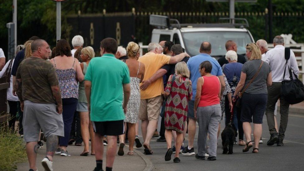 Residents of Wennington hugging each other