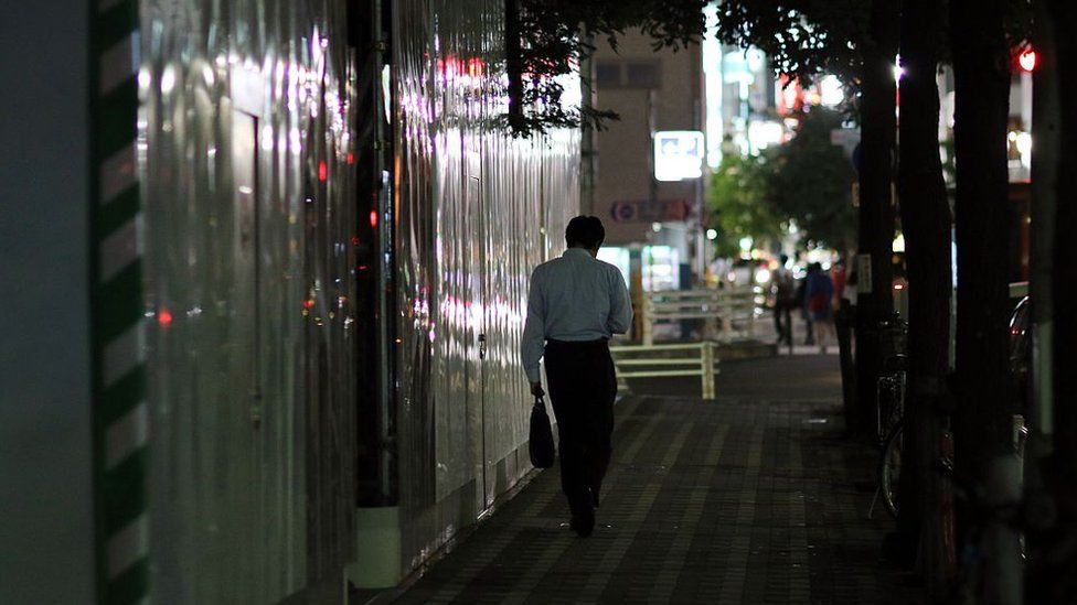 A businessman walking on a street in Tokyo