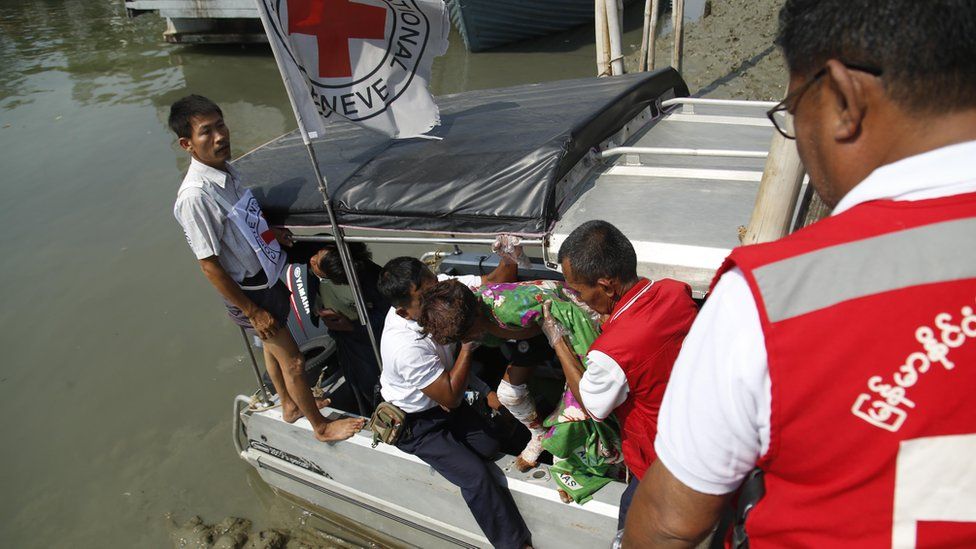 Members of the Myanmar Red Cross society move a wounded child from a boat to an ambulance that will transport him to Sittwe Hospital, in Sittwe, Rakhine State, western Myanmar, 24 March 2020