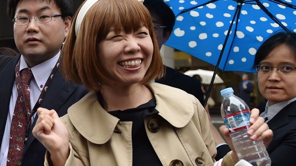Japanese artist Megumi Igarashi smiles as she speaks to reporters in front of the Tokyo District Court on May 9, 2016.