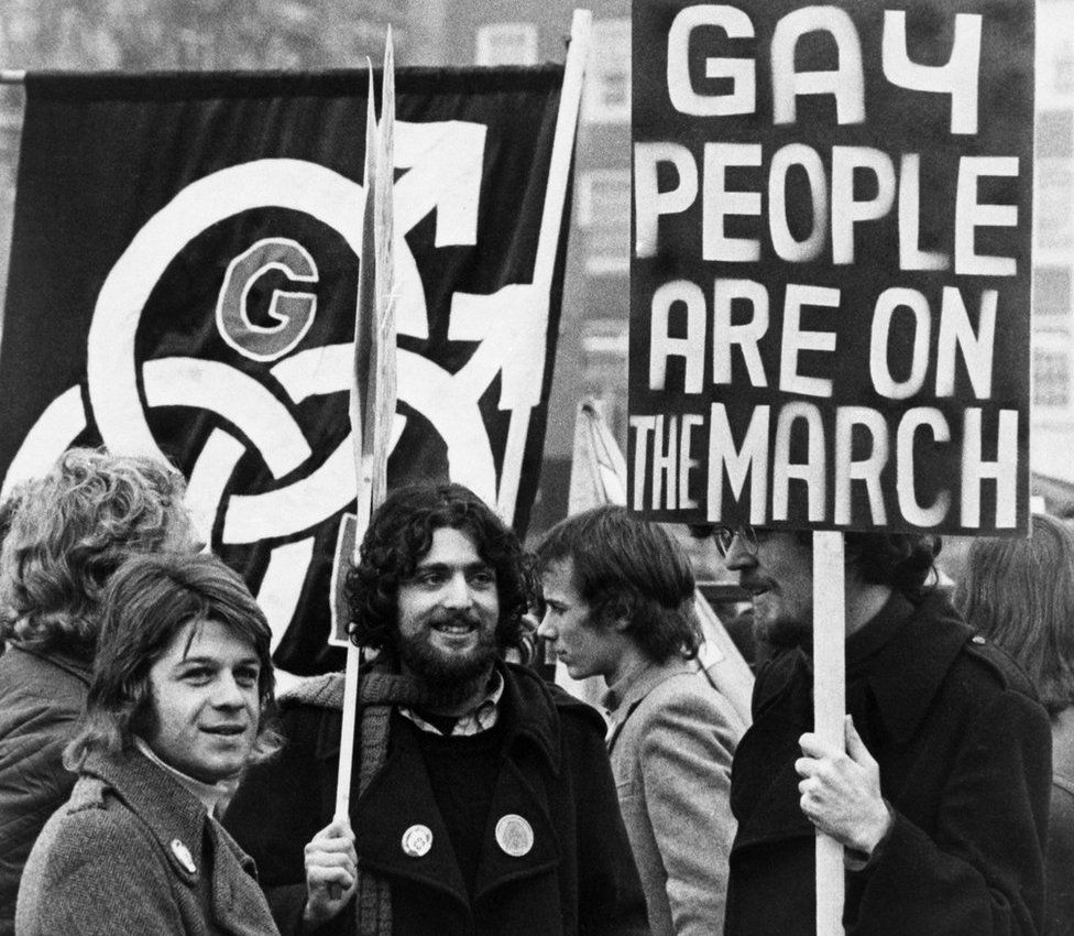 Black and white photo of protesters holding placards in 1971