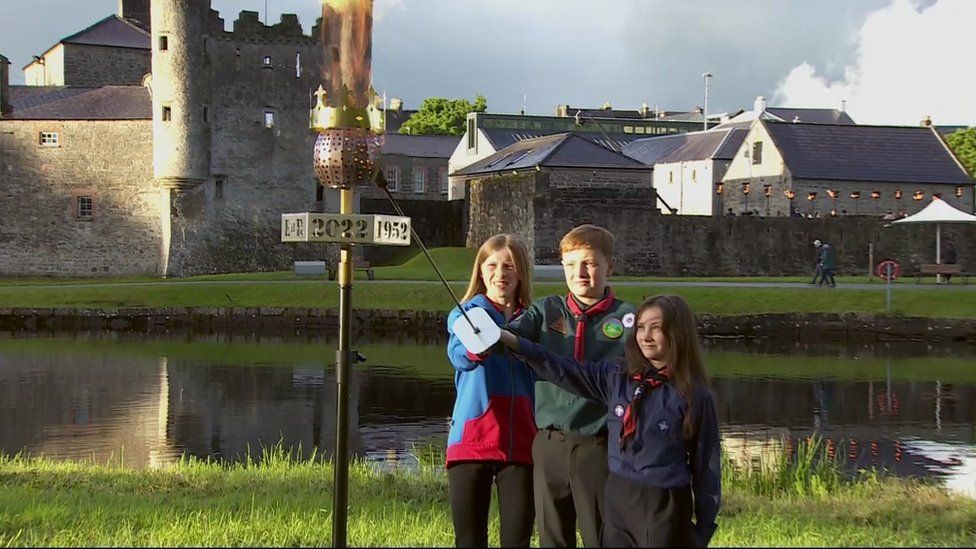 Local scouts Hayley Woods, Erin McCullough-Daley and Evan Clarke light beacon at Enniskillen Castle