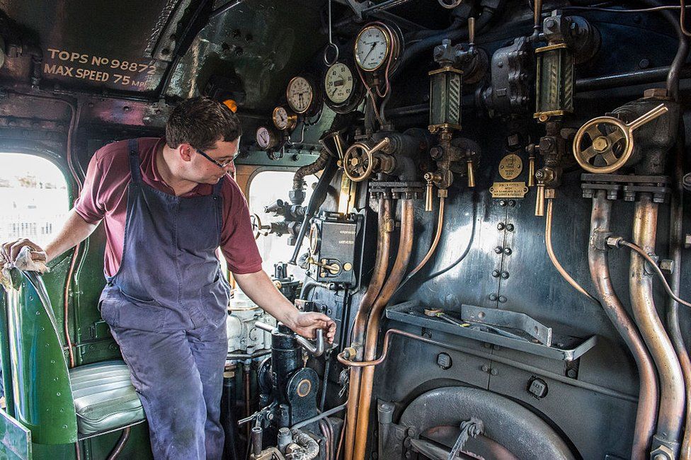 An engineer operates the controls on the footplates of the Flying Scotsman