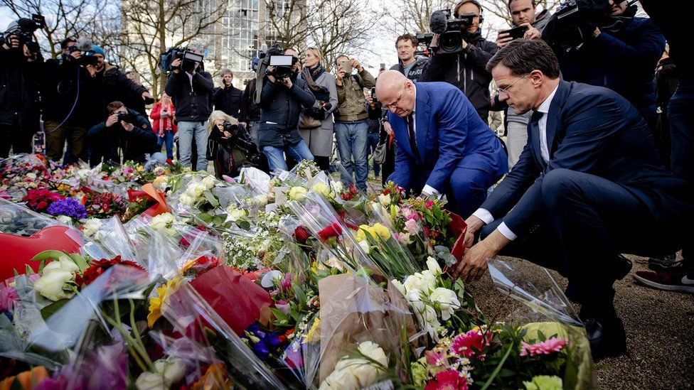 Dutch PM Mark Rutte and Justice Minister Ferdinand Grapperhaus (2nd R) laid flowers close to the scene of the attack