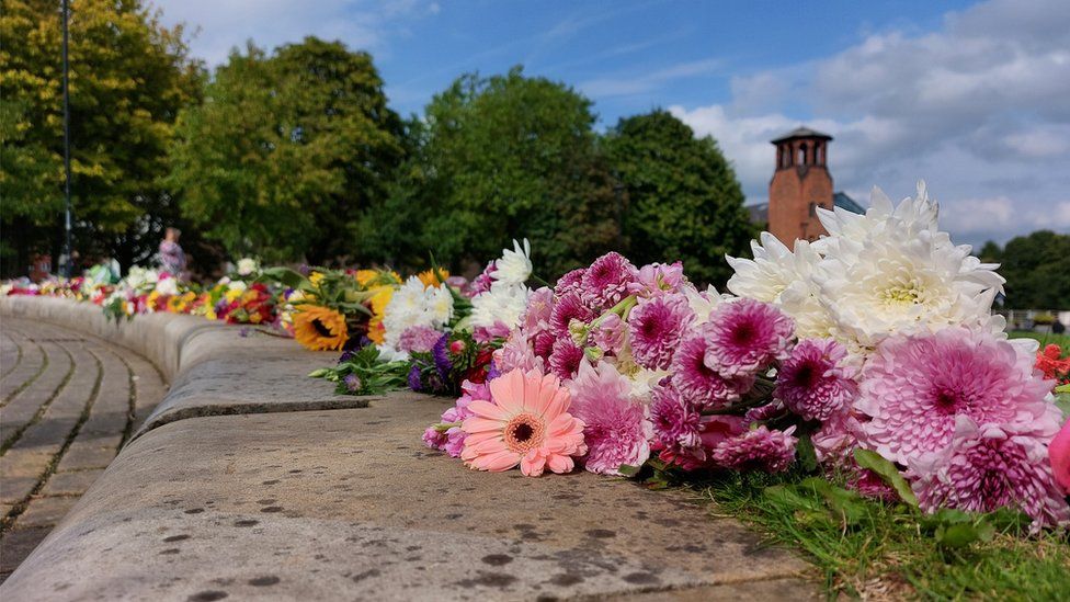 People laid flowers at Cathedral Green, in Derby