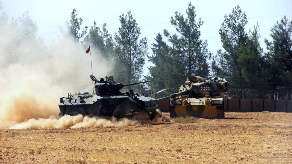 A Turkish army tank and an armoured vehicle are stationed near the border with Syria, in Karkamis, Turkey, Tuesday, 23 August 2016