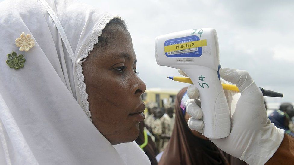A Muslim woman on pilgrimage to Mecca undergoes temperature checks for the ebola virus at at the Murtala Mohammed International Airport in Lagos on September 19, 2014.