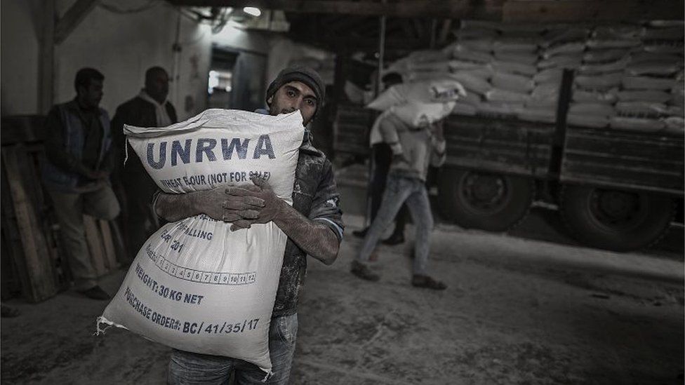 A Palestinian carries a sack of flour at a UN food centre in northern Gaza (15/01/18)