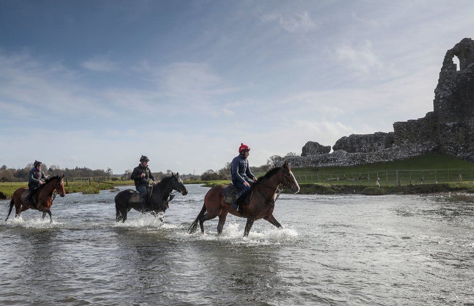 Horses from Christian Williams" stables in the river next to Ogmore Castle at his yard in Glamorgan. PA Photo. Picture date: Saturday March 21, 2020. All horse racing fixtures in Great Britain have been suspended until the end of April because of the coronavirus outbreak.