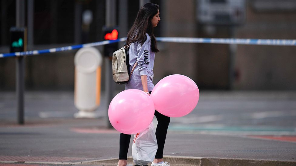 Young woman carrying balloons near the Manchester Arena attack