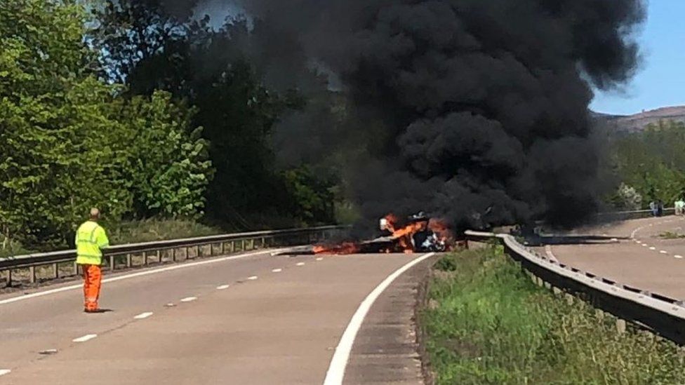 Plane in flames on the road