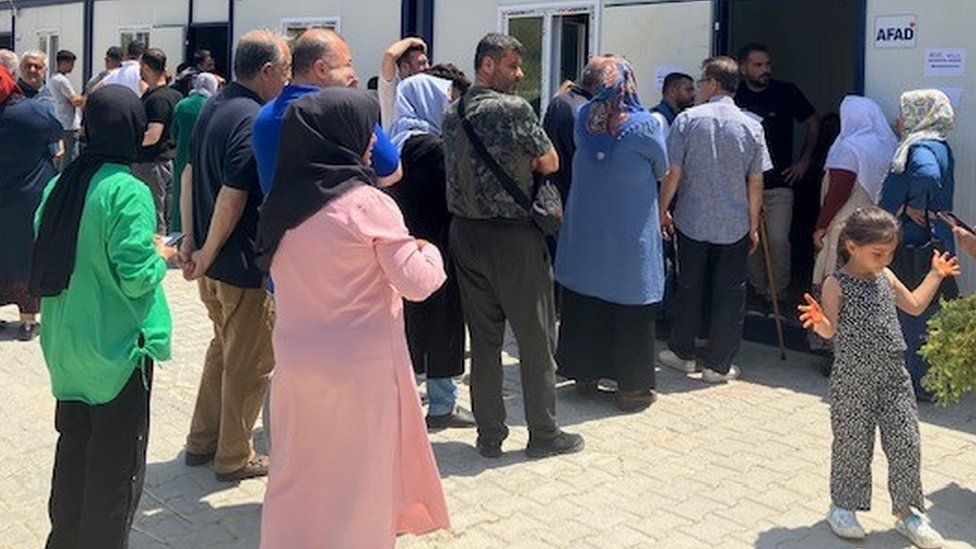 Voters in Antakya queued outside portable containers because the polling stations were unsafe