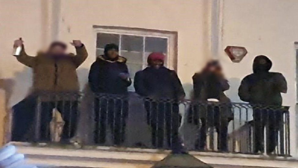 Three of the suspects partying on the balcony of the building