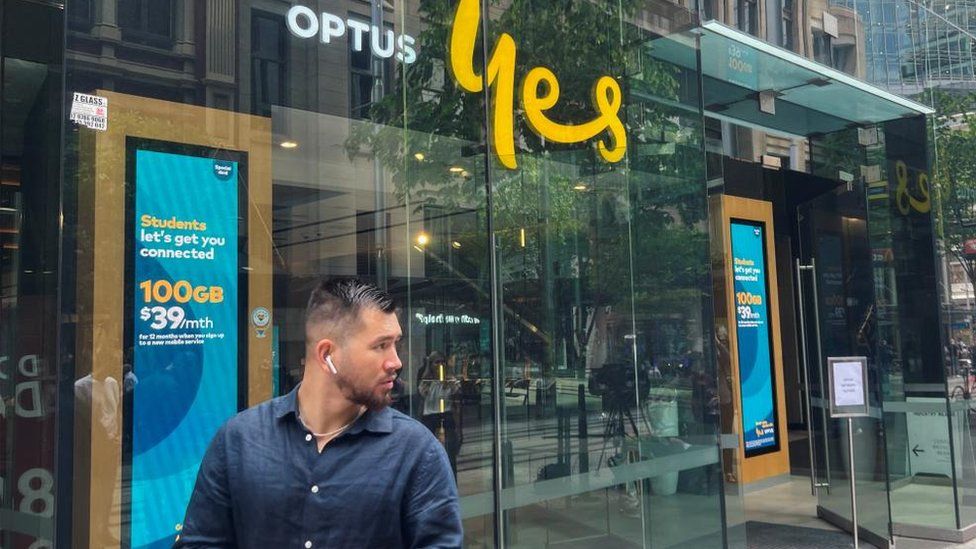 A customer outside an Optus store