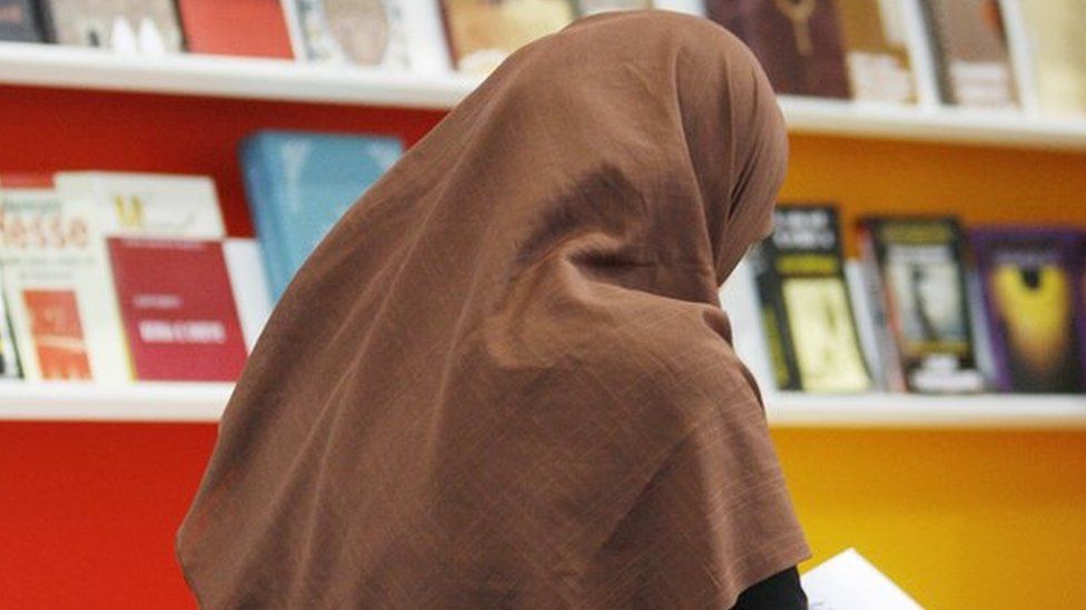 File pic of woman in library wearing headscarf