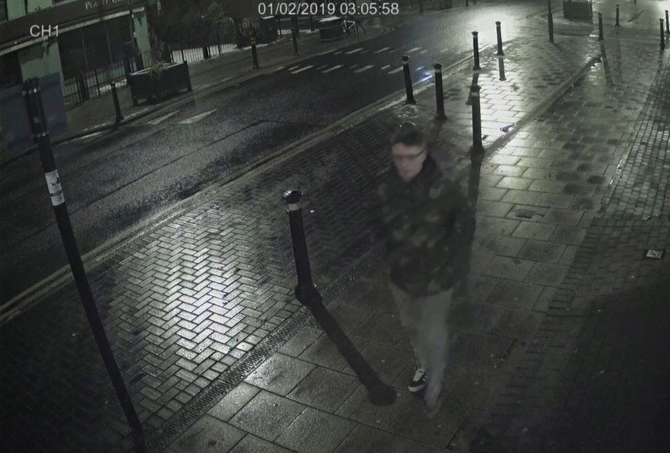 CCTV still of Pawel Relowicz walking on the pavement of a main road