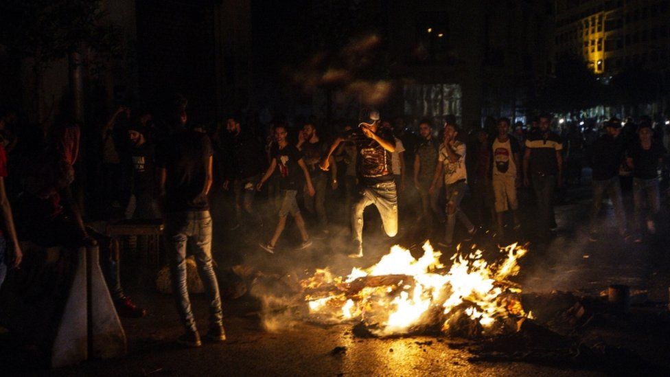 Protesters in Beirut burn tires near the presidential palace