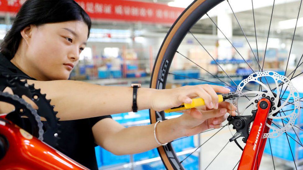 A worker assembles a bicycle at a company's carbon fibre bicycle production workshop in Leling city, Shandong province, China.