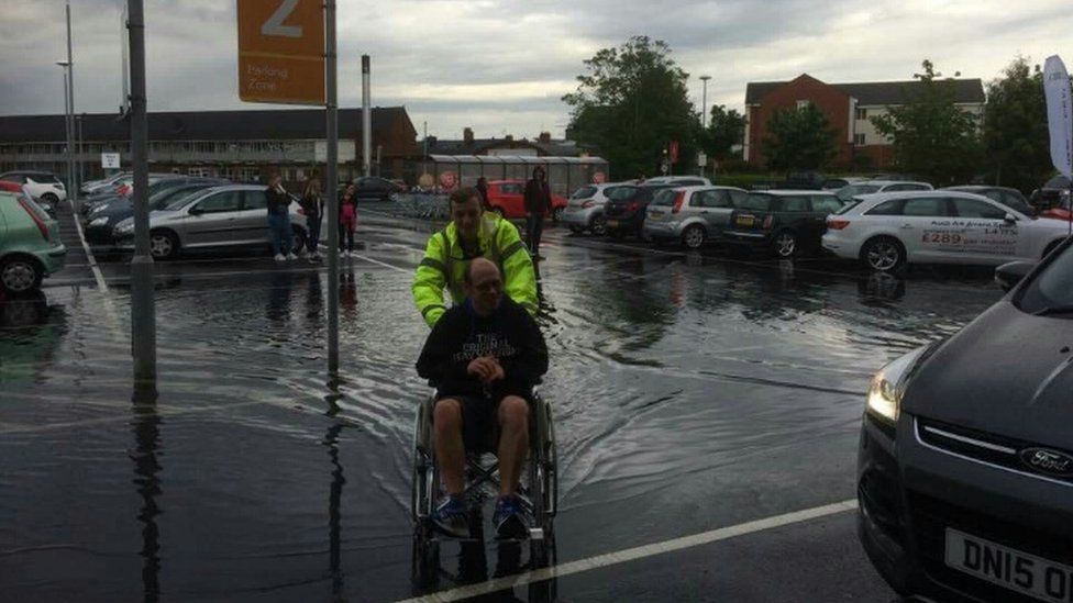 Stafford Tesco uses wheelchairs for flooded shoppers - BBC News