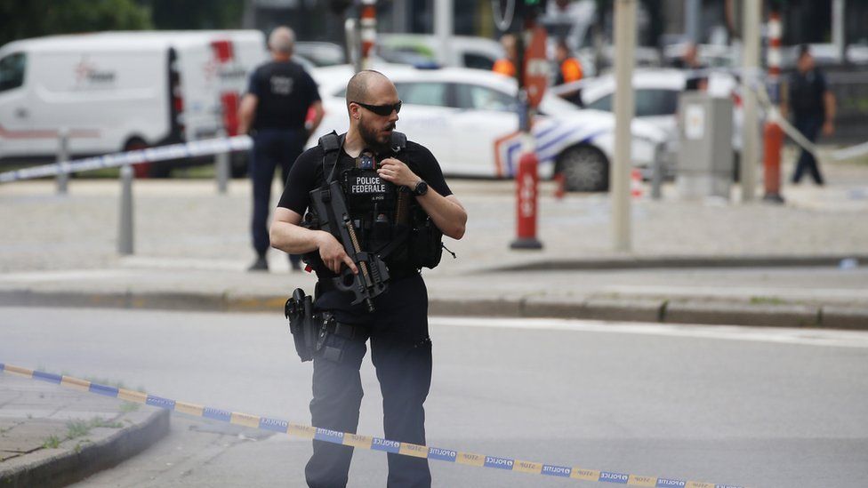 An armed policeman stands guard at the scene following a shooting in Liege, Belgium, 29 May 2018