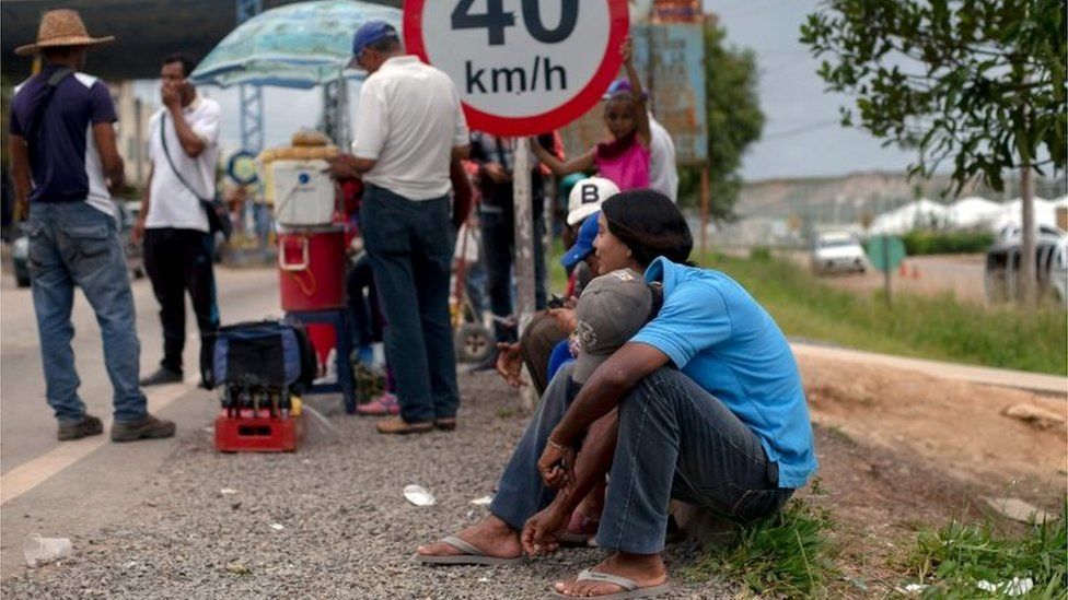 Venezuelan refugees queue outside the Brazilian Immigration Point in the border city of Pacaraima, Roraima, Brazil, on August 20, 2018.