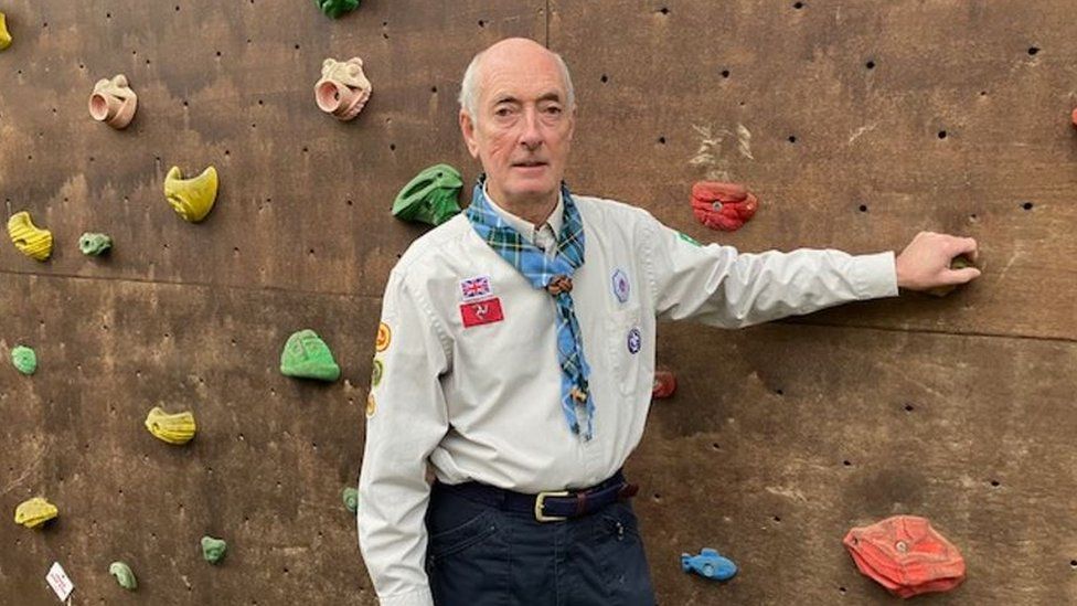 Guy Thompson by a climbing wall