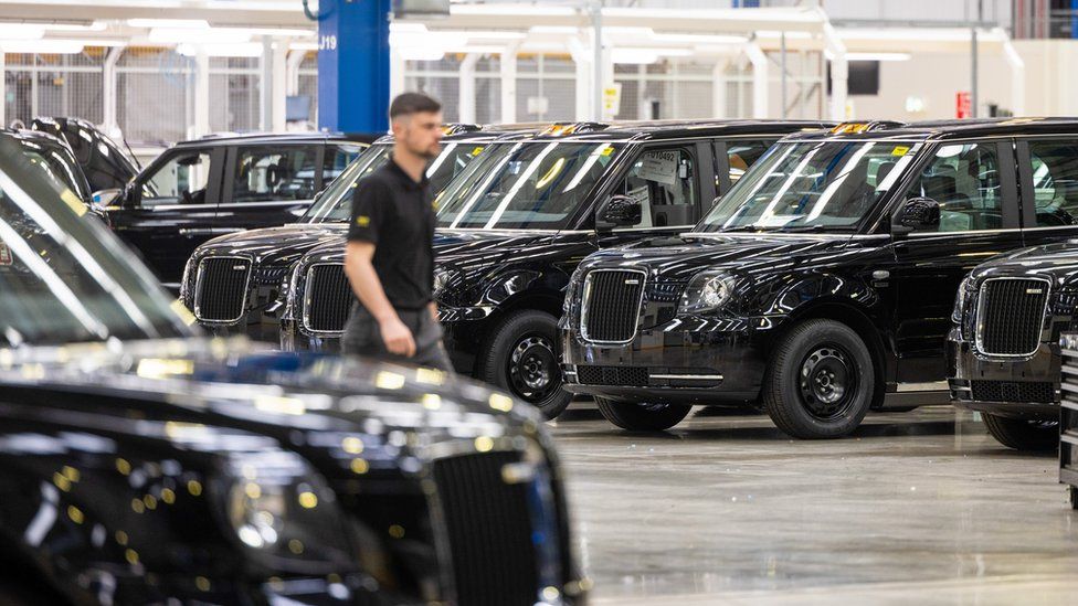 Newly manufactured TX electric London black cabs on the final assembly line at the London EV Co. (LEVC) manufacturing plant in Coventry, UK