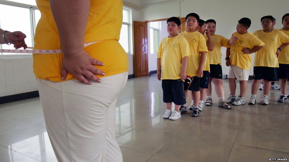 Children wait to be measured their waistline at a Slimming Centre in Wuhan