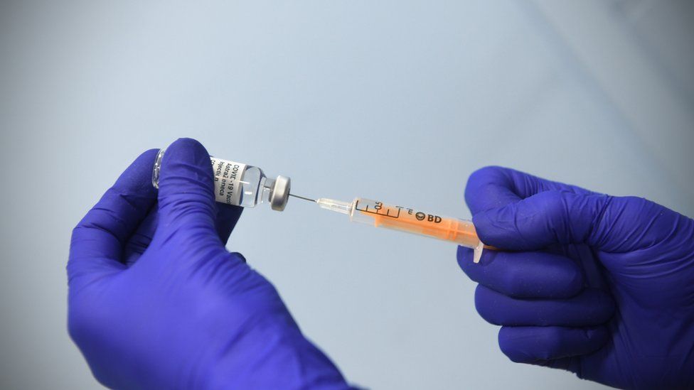 A dose of the Oxford-AstraZeneca coronavirus vaccine is prepared at a London vaccination centre