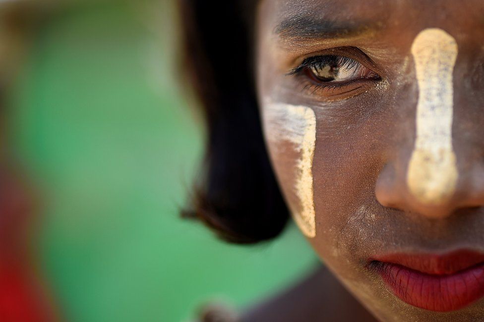 Rohingya refugee Shamima, aged 10, poses for a photograph as she wears thanaka paste at Jamtoli camp in Cox's Bazaar, Bangladesh