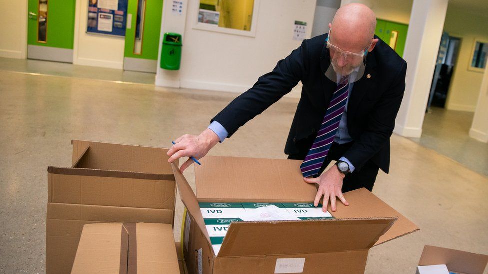 John Murphy, chief executive of Oasis Community Learning, unboxes Covid-19 testing kits at Oasis Academy Coulsdon in Coulsdon, south London