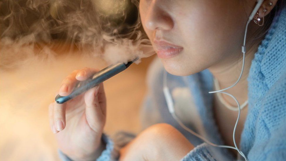 Young woman vaping