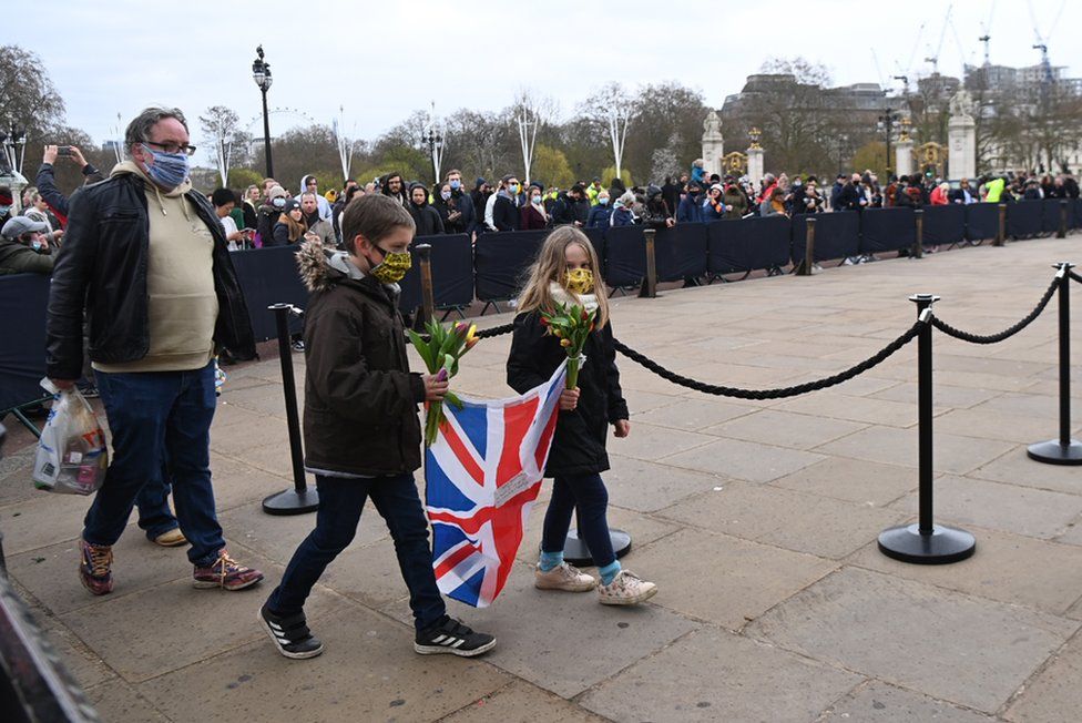 People gather outside Buckingham Palace a day after the passing of Britain's Prince Philip, Duke of Edinburgh, in London, Britain, 10 April 2021.