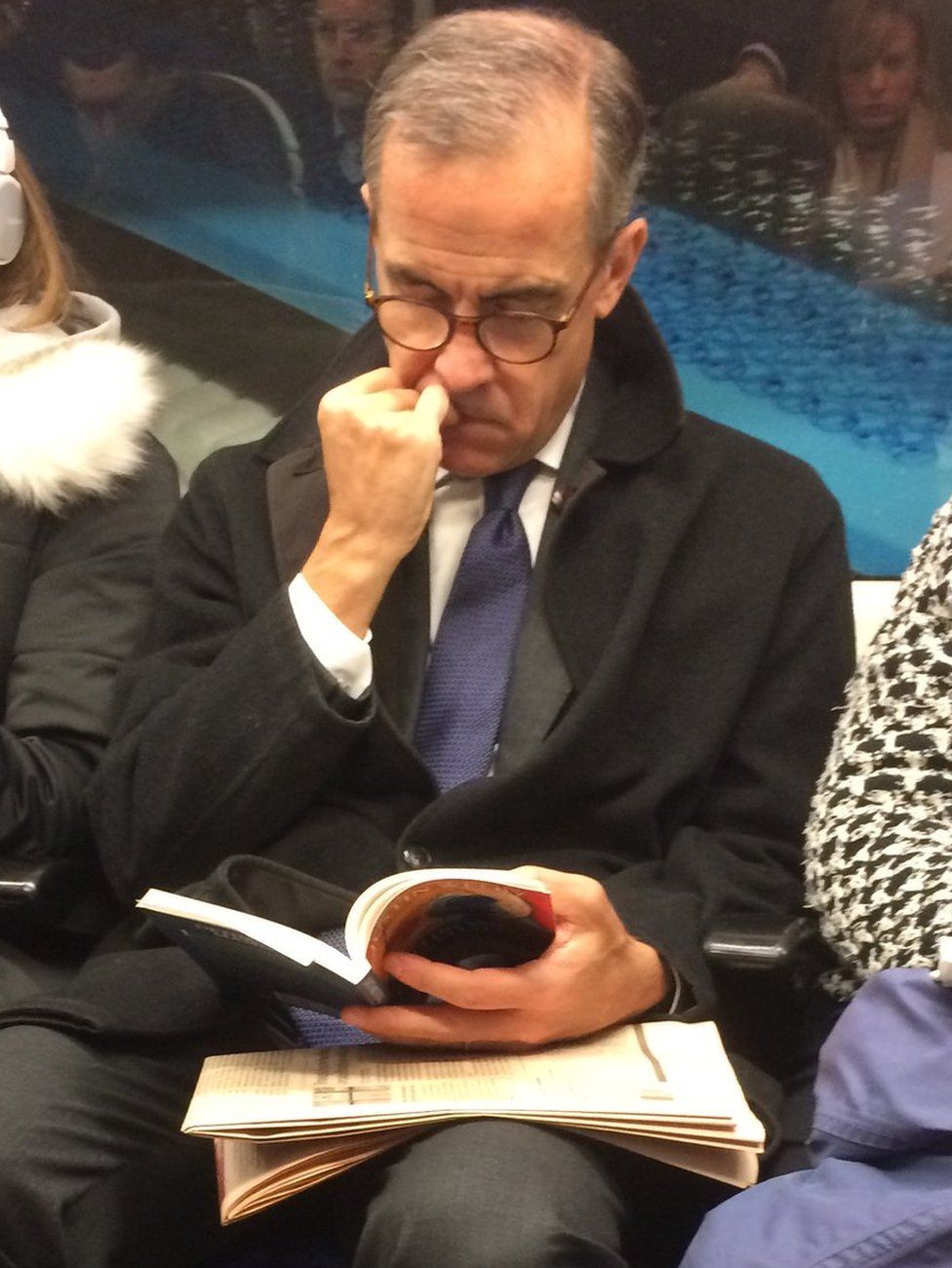 Mark Carney photographed on the tube reading Justin Welby's book