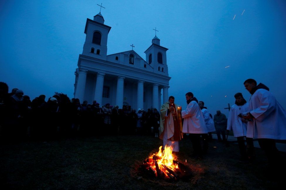 A Catholic priest conducts a service on Easter Eve in the village of Ragotna, Belarus March 31, 2018.