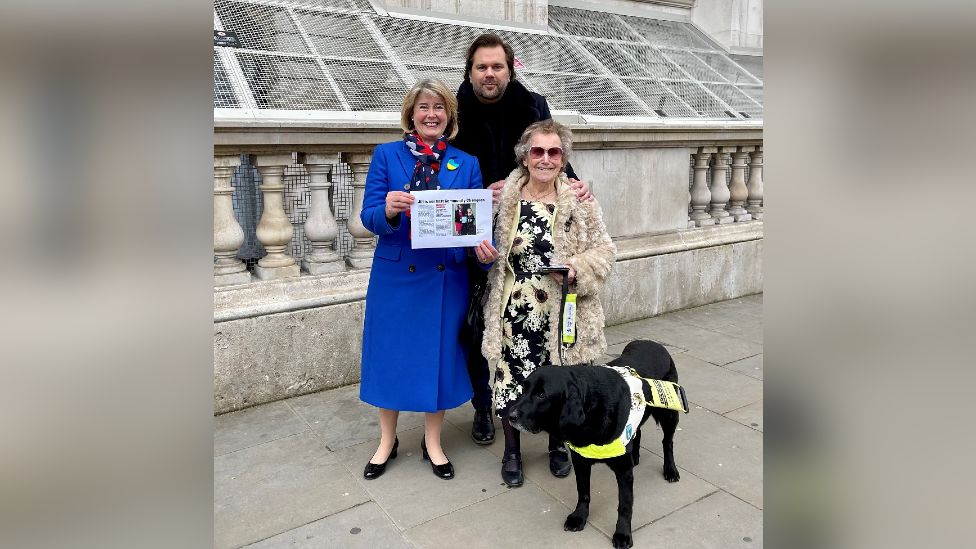 MP Anna Firth, BBC local radio presenter Justin Dealey, and Jill Allen-King with her guide dog Jagger
