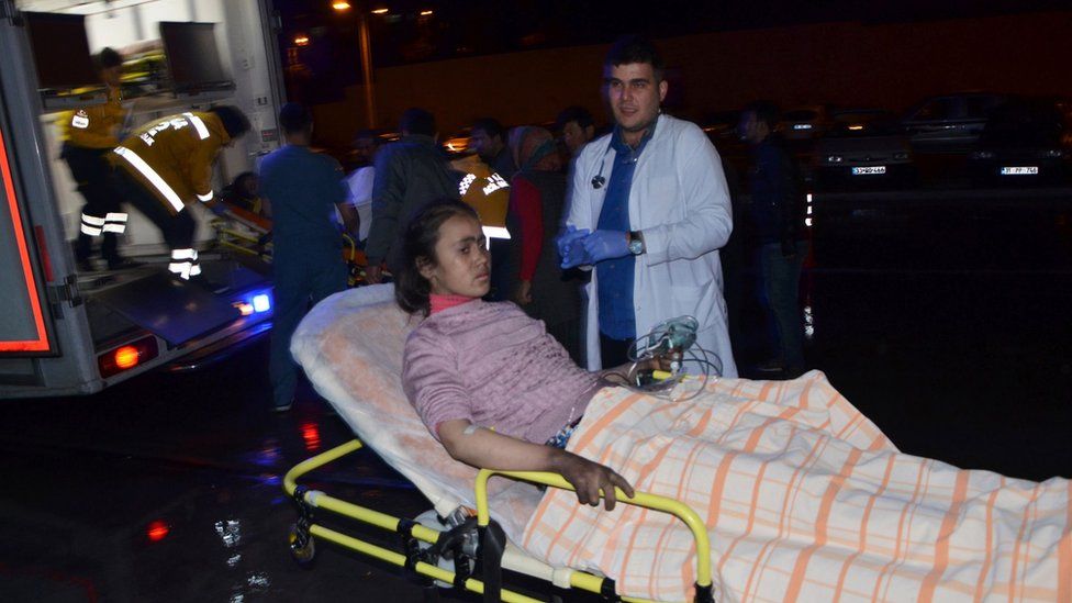 Injured girl is taken to hospital following a fire at a dormitory in Adana, southern Turkey, on November 29, 2016