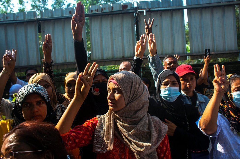 People flash three-finger salutes as they attend the funeral of U Khin Maung Latt in Yangon, 7 March