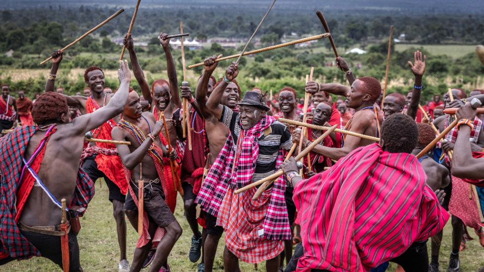 Young Maasai men confront a Maasai elder as part of the ceremonial activities during the Eunoto ceremony in a remote area near Kilgoris, Kenya.