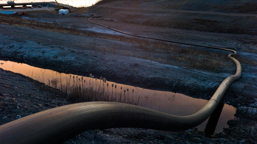 A water intake pipe for oil sands operations leads downhill to the Athabasca River on April 28th, 2015 north of Fort McMurray, Canada. Fort McMurray is currently coping with an economic downturn as a result of low oil prices and most of the layoffs have been impacting the transient workforce. Canada's oil and gas industry is expected to lose 37% of its revenues in 2015.