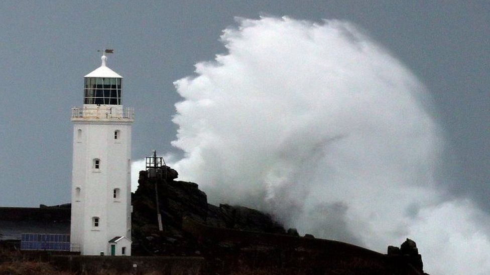 Waves crashing against Godrevy Lighthouse on Godrevy Island, Cornwall